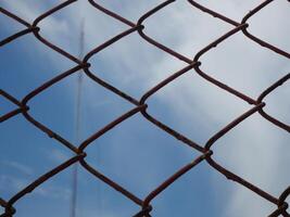 mesh wire fence with sky as background photo