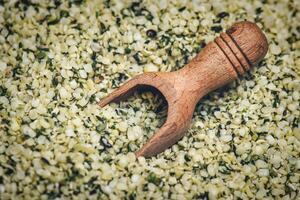 Detail of hemp seeds with wooden scoop photo