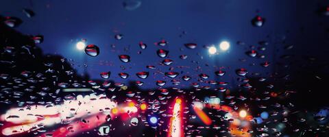 Driving in raining. Rain on car windshield or car window in rainy season and blurry traffic road in background. Rain drops on car mirror. Road in rain. Drizzle raining decreases driving visibility. photo