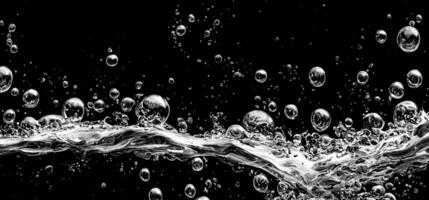 Soda water bubbles splashing underwater against black background. photo