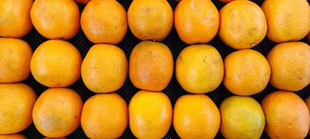 piles of fresh, fragrant oranges citrus in the supermarket photo