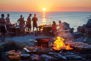 A group of people at a beach barbecue, cooking food over an open flame as the sun sets photo