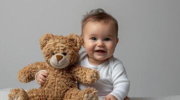 Smiling baby sitting with a teddy bear, on a simple studio backdrop with plenty of blank space, perfect for baby product advertisements and cute themes photo