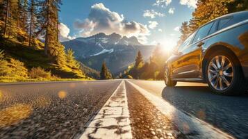 A car driving down a scenic highway with mountains and forests in the background photo