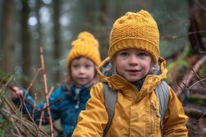 Children exploring the woods and collecting sticks near their campsite photo