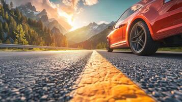 A car driving down a scenic highway with mountains and forests in the background photo