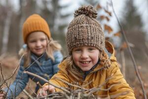 Children exploring the woods and collecting sticks near their campsite photo