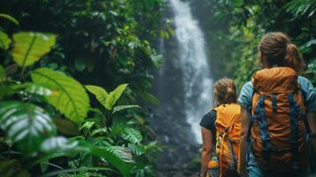 Hikers encountering a waterfall hidden deep within a lush forest photo