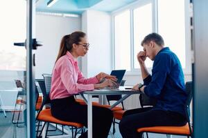 A furious business director of a startup office berating her employee for business mistakes and errors photo