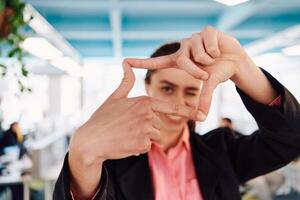 Closeup of hands, Smiling Business Woman Making Frame Gesture with at modern bright coworking open space startup office photo
