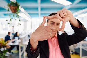 Closeup of hands, Smiling Business Woman Making Frame Gesture with at modern bright coworking open space startup office photo