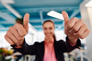 Closeup of hands, Smiling Business Woman Making Frame Gesture with at modern bright coworking open space startup office photo