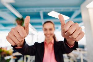 Closeup of hands, Smiling Business Woman Making Frame Gesture with at modern bright coworking open space startup office photo