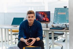 Programming. Man Working On Computer In IT Office, Sitting At Desk Writing Codes. Programmer Typing Data Code, Working On Project In Software Development Company photo