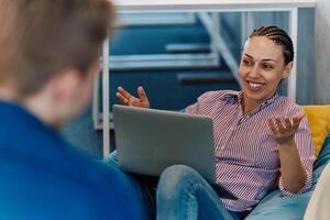 A modern programmer discussing future business projects with colleagues in a modern startup office photo