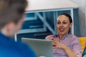 A modern programmer discussing future business projects with colleagues in a modern startup office photo