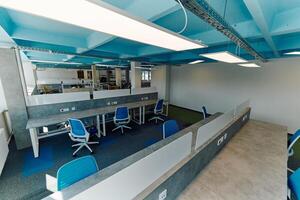 Photo of a modern office where programming, digital marketing and web design projects are done. Office with modern furniture and glass office