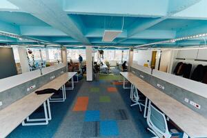 Photo of a modern office where programming, digital marketing and web design projects are done. Office with modern furniture and glass office