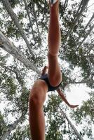 Adventurous Woman Overcoming Forest Obstacles with Determination and Agility. photo