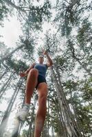 Adventurous Woman Overcoming Forest Obstacles with Determination and Agility. photo