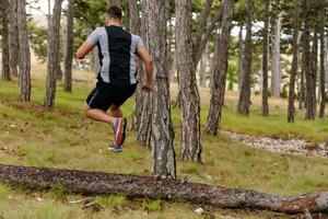 Determined Man Conquering Forest Obstacles with Grit and Speed photo