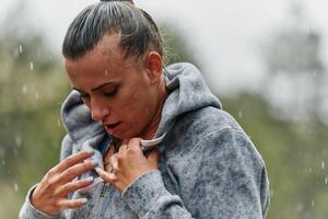 Woman Resting in the Rain After Intense Run photo
