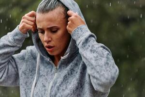 Woman Resting in the Rain After Intense Run photo
