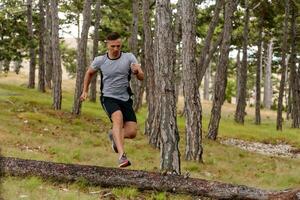 Determined Man Conquering Forest Obstacles with Grit and Speed photo