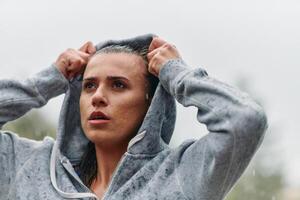 Woman Resting in the Rain After Intense Run photo