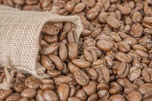 Roasted coffee beans as a background. Coffee in a bag. photo