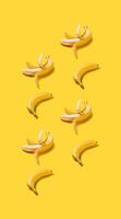 Banner vertical bananas with hard shadows pattern on yellow background photo