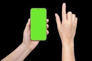 A woman's hand holds a phone chromakey Mockup and the second hand with a finger presses a button or scrolls. Isolated on black background close up photo