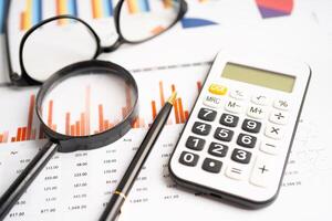 Calculator on chart graph paper. Finance, account, statistic, investment data economy, stock exchange business. photo