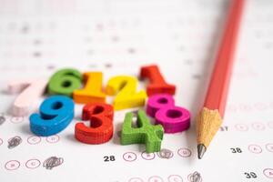 Pencil on answer sheet paper with math, Education study testing learning teach concept. photo