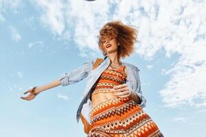 Beach Goddess. A Smiling Woman Embracing Freedom and Happiness on a Summer Vacation, Dancing with photo