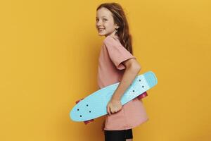 Young Woman with Skateboard on Yellow Background photo