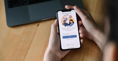 CHIANG MAI, THAILAND - JUNE 22, 2020 . A working from home employee is downloading the Microsoft Teams social platform, ready for remote working in isolation from home photo