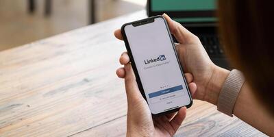 CHIANG MAI, THAILAND - SEP 26, 2021. iPhone X with LinkedIn application on the screen. LinkedIn is a business-oriented social networking service photo