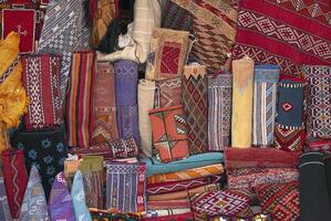 Moroccan carpets and rugs, handwoven by the berber tribes on display. Variety of carpets styles, patterns and colors. photo