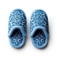 Cozy blue slippers with a pattern and isolated on a white background. Top view photo