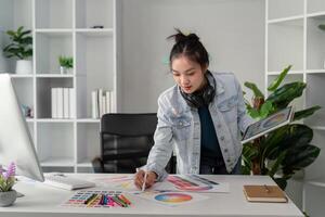 UX designer. Work on creative applications. Man with a palette in his hands. Designer applies the primary colors to the monitors. Development of a training application. Designer is a freelancer photo