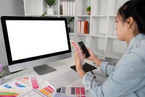 Woman sit at workplace desk with digital graphic staring at computer white mock up screen working professional program concept photo