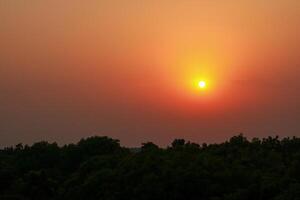 Sunset over the forest in the evening. Beautiful nature background. photo