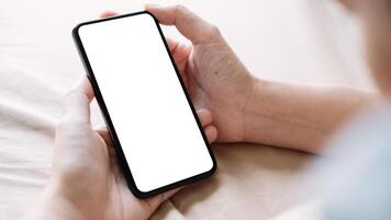 Close up Woman hand Using a Smart Phone with white screen at home photo