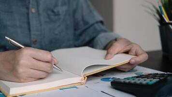 A woman using note some data on notepad for financial calculating photo