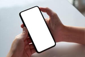 Top view Woman sitting and holding blank screen mock up mobile phone photo