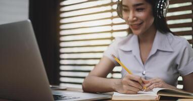 Smiling girl student wear wireless headphone study online learn language listen lecture photo