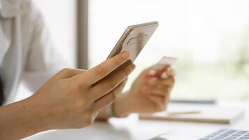Shopping online with smartphone and credit card on hand photo