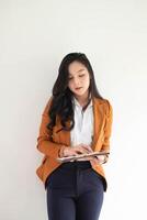 Portrait Of Attractive Asian Businesswoman standing working from document financial reports photo