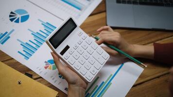 Close up of bookkeeper or financial inspector hands making report, calculating or checking balance. photo